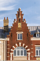 Fototapeta premium ornate historic townhouses with distinct architectural styles. The scene captures the charm of coastal architecture in Dunkirk, France