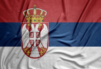 tricolor flag of the European country Serbia with a beautiful coat of arms on a rough canvas with...
