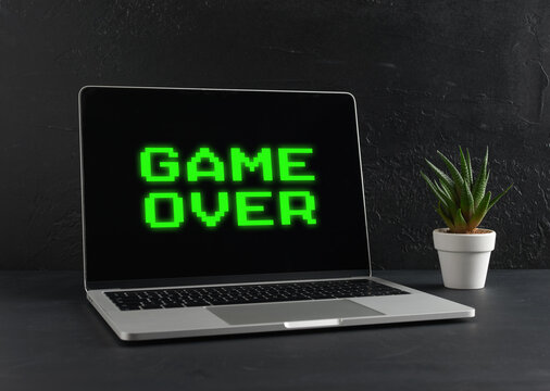 Laptop Showing Game Over Message on Black Background