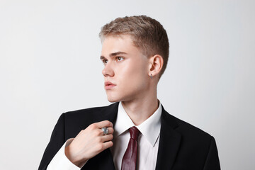 Handsome young man wearing stylish suit on white background