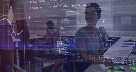 Smiling participant engaging in discussion in training room, with laptops, code overlay, copy space