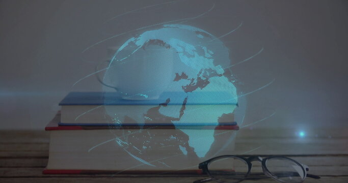 Projecting holographic globe above three hardcover books with eyeglasses on wooden desk in study - Powered by Adobe