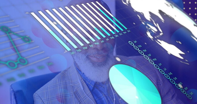 Senior man wearing plaid blazer analyzing floating bar and pie charts in office, with world map - Powered by Adobe