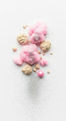 Close up of pastel pink and beige cosmetic powder with shimmering glitter particles isolated on transparent background
