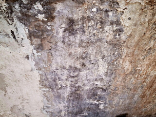 Weathered brown concrete wall with a rough, grungy texture and peeling paint