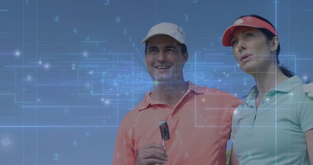Holding putter, golf couple standing on fairway, with coral and mint polos, visors and grid overlay