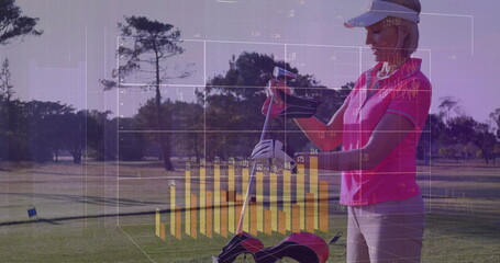 Golfer adjusting club grip in pink polo at golf tee, with trolley, chart overlay, copy space