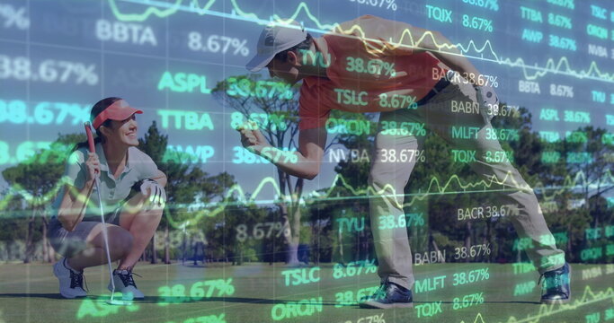 Golf partners in polos holding putter and fist bumping on putting green, with stock chart overlay - Powered by Adobe