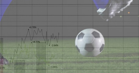 Player's cleated foot striking soccer ball on trimmed grass pitch, with financial data overlay
