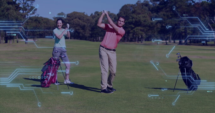 Swinging clubs with golf bags, couple wearing polos practicing on fairway, with digital HUD overlay - Powered by Adobe