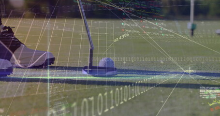 Aligning golf putter head over ball at putting green, with spiked shoe and digital data overlays