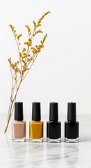 Four bottles of nail polish in neutral and dark shades with a delicate dried flower sprig isolated on transparent background