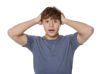 Teenage boy suffering from panic attack on white background