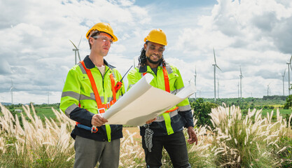 Two men in safety gear are looking at  piece of paper
