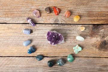 Aura. Different natural mineral stones on wooden table, flat lay