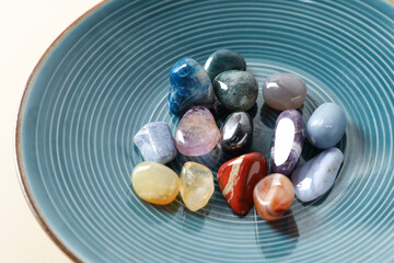 Aura. Different natural mineral stones on beige background, closeup