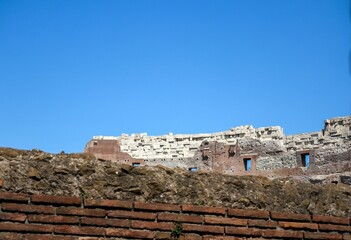 Ancient Colosseum ruins under blue sky