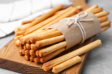 Delicious grissini sticks on grey table, closeup
