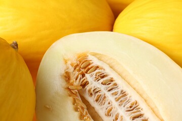 Whole and cut ripe melons as background, closeup