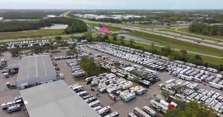 Aerial view of new motorhomes parked for sale at dealership parking lot in Ft. Myers, Florida. RV industry in USA.
