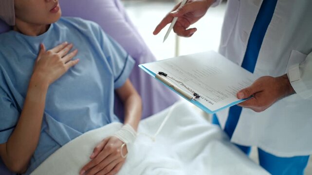 Close up at patient and doctor hands while consulting and examing disease on
medical chart clipboard for discussion the treatment results, medical clinic or
hospital and healthcare service concept.