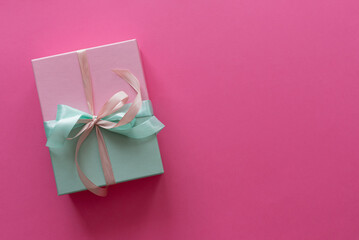 Christmas gift on a pink background.