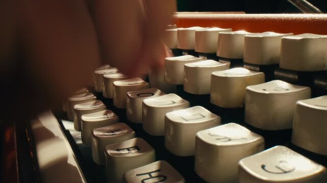 Typewriter close up, writer Typing on an old vintage antique typewriter - close up of hands on keys