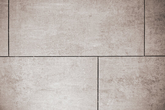 Close-up of uniformly laid large format ceramic tiles with straight lines without grout