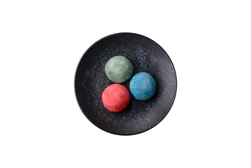 Japanese mochi, ice cream or Asian sweets with fruit filling. Mochi of different colors