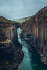 Stuðlagil gorge in northern Iceland. About 60km east from Egilstadir. Beautiful and regular basalt columns and a nicely colored glacial river.