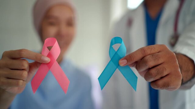 Hand of patient woman with needle intravenous saline showing pink ribbon on hospital bed for rising breast cancer awareness on October day, health care and supporting people life concept.