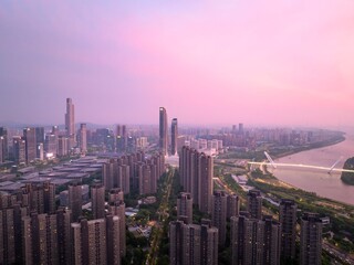 Fototapeta premium Nanjing skyline glows with warm hues during a stunning summer sunset in a vibrant urban landscape