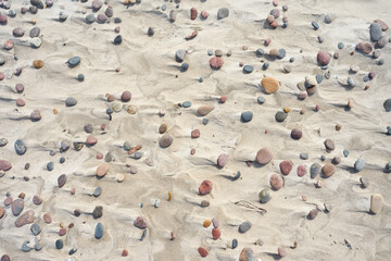 Pebbles on sand beach. Pebbles on the beach for background and texture. 