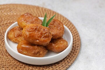 Kue Gemblong. Gemblong is made from white glutinous rice flour dough which is kneaded until smooth and shaped into a slightly flat oval and coated with sugar.