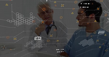 Senior doctor leaning as younger clinician tapping tablet showing medical hex interface for review - Powered by Adobe