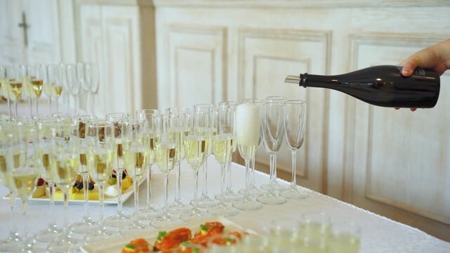 Champagne is poured into elegant flutes, making it the perfect drink for celebrations and memorable events. Enjoying Elegant Champagne Pouring at a Celebration to Create Unforgettable Memories