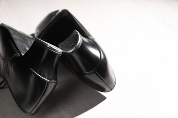 Pair of shoes for tap dance on white wooden floor, closeup. Space for text