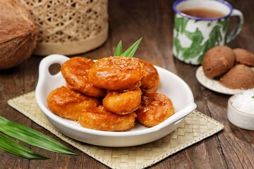 Kue Gemblong. Gemblong is made from white glutinous rice flour dough which is kneaded until smooth and shaped into a slightly flat oval and coated with sugar.