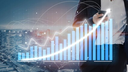 A businessman in a suit holds a smartphone while analyzing growth data, with a digital graph overlay and an urban city skyline in the background, emphasizing modern finance. Copula