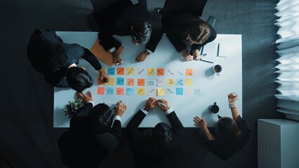 Time lapse of professional business team discuss while project manager join meeting. Group of diverse people writing and choose marketing idea or plan on table with sticky notes placed. Directorate..