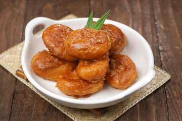 Kue Gemblong. Gemblong is made from white glutinous rice flour dough which is kneaded until smooth and shaped into a slightly flat oval and coated with sugar.
