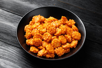 Spicy chilli rice crackers in white bowl. Party food snacks