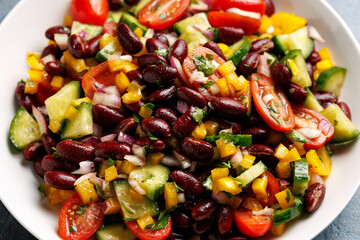 Red kidney bean salad with cucumber, tomatoes, bell pepper and parsley. Healthy food