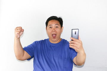 young man with a mobile phone with success gesture