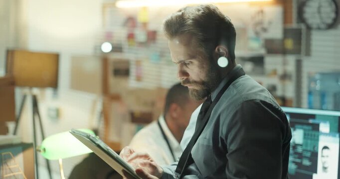Detective, research and tablet with man in office for criminal records, arrest warrant and night. Crime investigation deadline, evidence report and digital testimony with person in police department