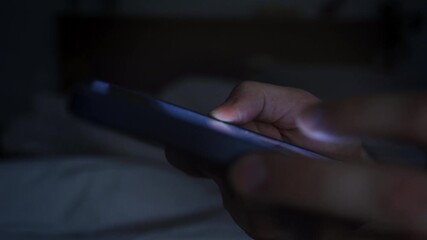 Smartphone and social network addiction concept. Hands using smartphone in bed at night - Powered by Adobe