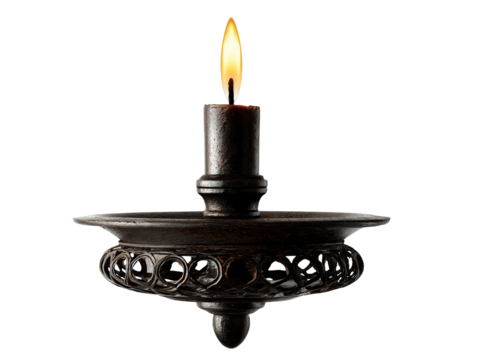 A single lit candle in a dark rustic metal holder with an ornate openwork design.