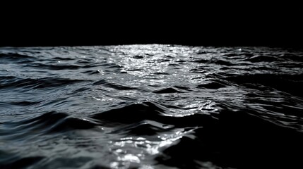Moonlit waves glistening in the dark ocean night with reflective waters