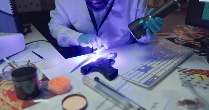 Hands, forensics and uv light for gun with evidence, brush and dust for fingerprints at laboratory. Person, firearm and murder weapon with search for lead, inspection and police examination for proof