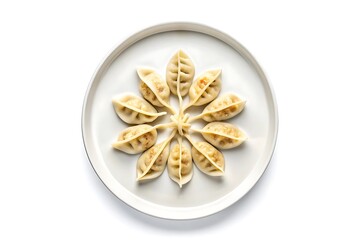 Delicious golden brown pan fried dumplings arranged in a beautiful flower pattern on a white plate